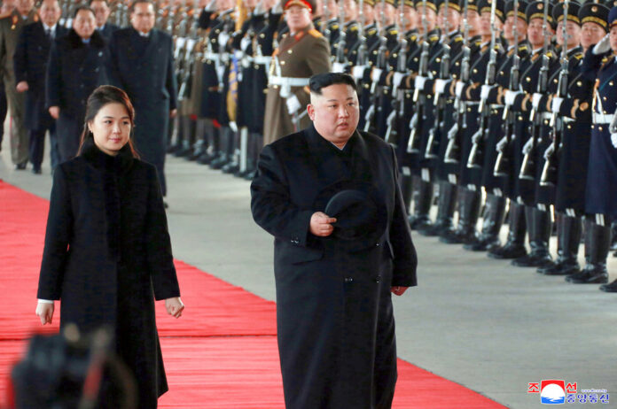 In this Monday, Jan. 7, 2019, photo provided on Tuesday, Jan. 8, 2019 by the North Korean government, North Korean leader Kim Jong Un walks with his wife Ri Sol Ju at Pyongyang Station in Pyongyang, North Korea, before leaving for China. Photo: Korean Central News Agency / Korea News Service via AP