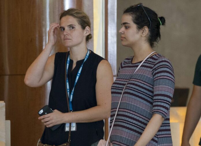 Rahaf Mohammed Alqunun, right, on Friday walks with an unidentified companion in Bangkok. Photo: Sakchai Lalit / Associated Press