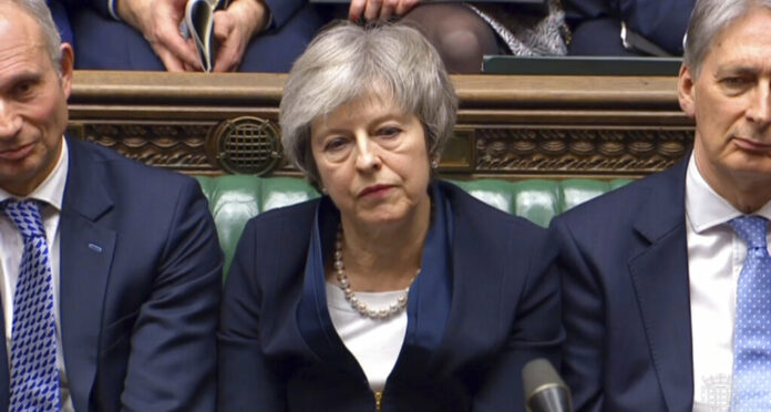 In this grab taken from video, Britain's Prime Minister Theresa May listens to Labour leader Jeremy Corbyn speaking Tuesday after losing a vote on her Brexit deal, in the House of Commons, London. Photo: Associated Press In this grab taken from video, Britain's Prime Minister Theresa May listens to Labour leader Jeremy Corbyn speaking Tuesday after losing a vote on her Brexit deal, in the House of Commons, London. Photo: Associated Press