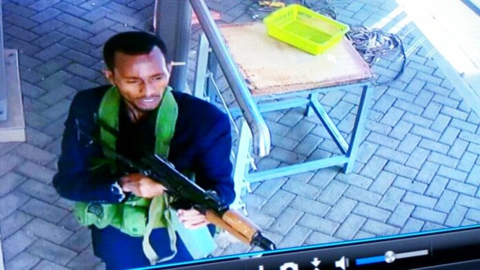 In this grab taken from security camera footage released to the local media, an armed attacker walks in the compound of a hotel, in Nairobi, Kenya on Tuesday. Photo: Security Camera Footage via Associated Press