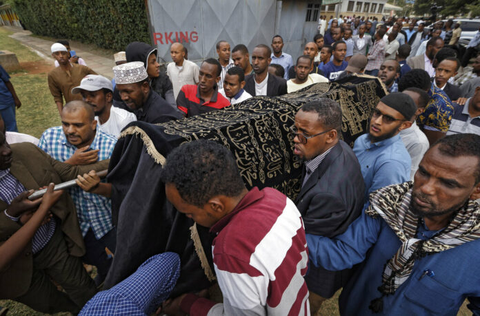 Mourners on Wednesday carry the body of Feisal Ahmed, who was killed with his colleague Abdalla Dahir in Tuesday's attack, as they leave a mosque and head to the funerals in Nairobi, Kenya. Photo: Ben Curtis / Associated Press