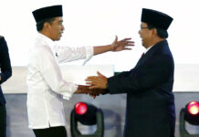 Indonesian Presidential Candidates Spar Over Corruption Indonesian President Joko Widodo, left, and his contender Prabowo Subianto, shake hands after a televised debate Thursday in Jakarta, Indonesia. Photo: Tatan Syuflana / Associated Press