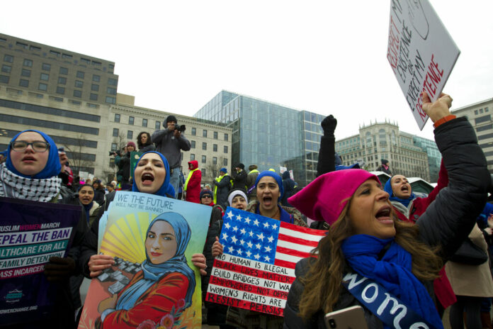 A group hold up signs at freedom plaza during the women's march in Washington on Saturday, Jan. 19, 2019. Photo: Jose Luis Magana / Associated Press