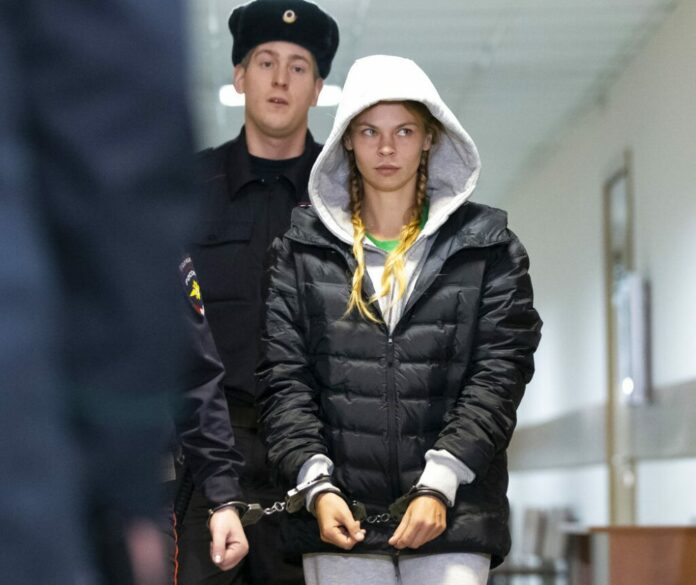 Anastasia Vashukevich, also known on social media as Nastya Rybka, on Saturday is escorted in the court room in Moscow, Russia. Photo: Alexander Zemlianichenko / Associated Press