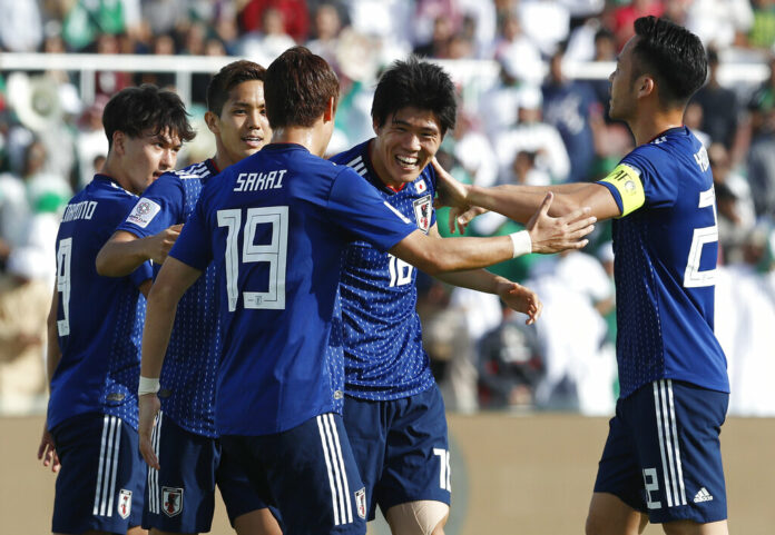 Japan's defender Takehiro Tomiyasu, second right, celebrates Monday after scoring the opening goal during the AFC Asian Cup round of 16 soccer match between Japan and Saudi Arabia at the Sharjah Stadium in Sharjah, United Arab Emirates. Photo: Hassan Ammar / Associated Press