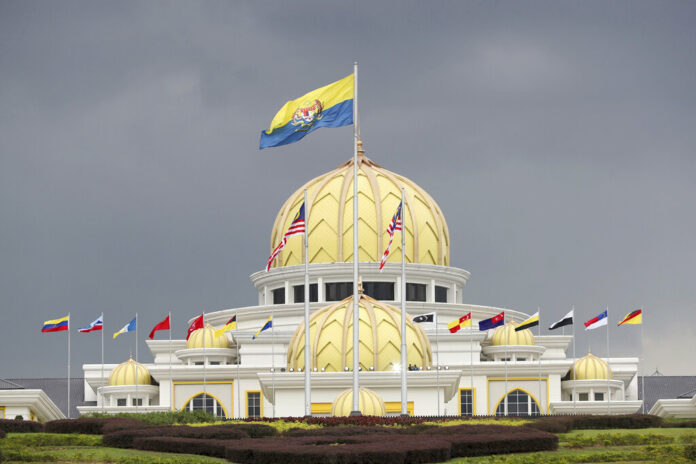 Flags fly Thursday at the Malaysia National Palace in Kuala Lumpur, Malaysia. Photo: Vincent Thian / Associated Press