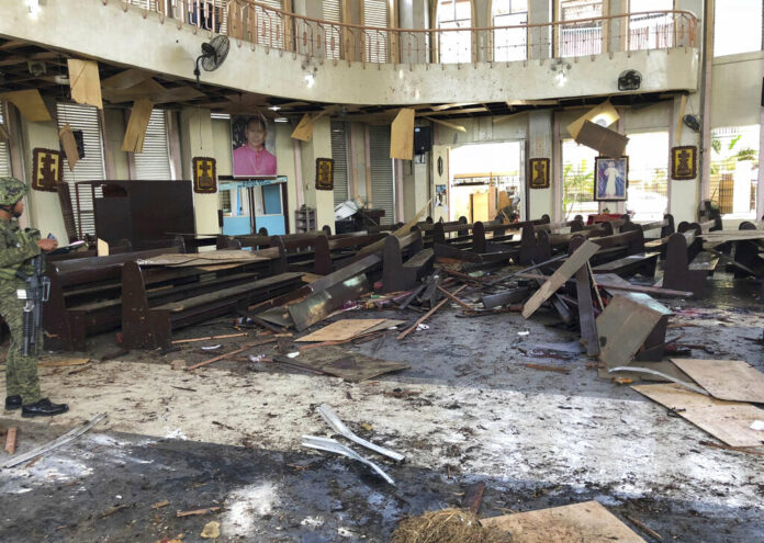 A soldier views the site inside a Roman Catholic cathedral Sunday in Jolo, the capital of Sulu province in the southern Philippines after two bombs exploded. Photo: WESMINCOM Armed Forces of the Philippines Via AP