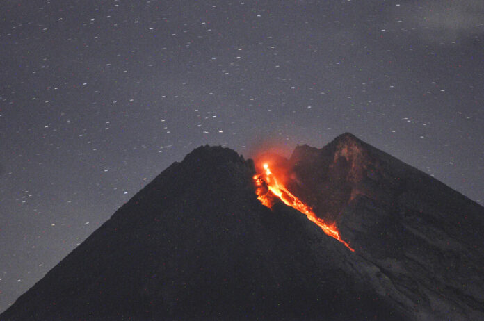 Mount Merapi spews volcanic material as it erupts as seen Tuesday from Cangkringan, Yogyakarta, Indonesia. Photo: Slamet Riyadi / Associated Press