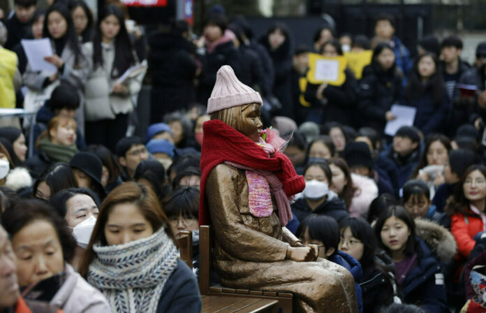 A statue of a girl representing thousands of Korean women enslaved for sex by Japan's imperial forces before and during World War II, is seen on Wednesday during a weekly rally near the Japanese Embassy in Seoul, South Korea. Photo: Lee Jin-man / Associated Press