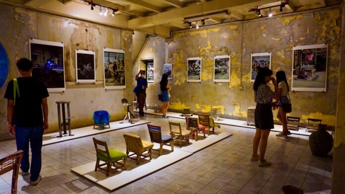 Visitors check out displays on the opening day of Bangkok Design Week Saturday in Talad Noi area.