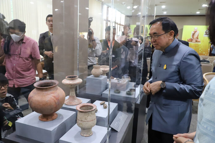 Culture Minister Vira Rojpojchanarat surveys Thai artifacts returned from the United States at the National Library on Thursday in Bangkok.