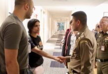 Saudi Officials ‘Satisfied’ by Handling of Rahaf: Big Joke Rahaf Alqunun shakes hand with immigration chief Surachate Hakparn, at right, Monday at Bangkok's Suvarnabhumi Airport. Photo: Immigration Bureau