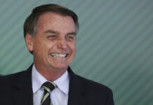 Bolsonaro Loosens Gun Laws in Brazil, World Murder Capital Brazil's President Jair Bolsonaro smiles during a ceremony where he signed a decree loosening restrictions on owning firearms Tuesday at Planalto presidential palace in Brasilia, Brazil. Photo: Eraldo Peres / Associated Press
