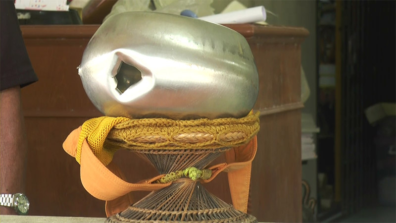 A monk's alms bowl purportedly hit by a bullet in last week's attack on a temple in Narathiwat province is displayed after the attack.