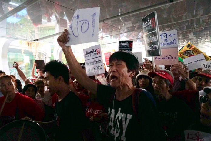 A sole counter-protester proclaims he is 'Bored!' of elections at a pro-democracy rally held Jan. 8 at the Ratchaprasong intersection in Bangkok.