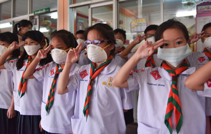 Students wear masks at at Patai Udom Suksa School on Jan. 15 in Bangkok, where all outdoor activities and physical education classes were canceled.