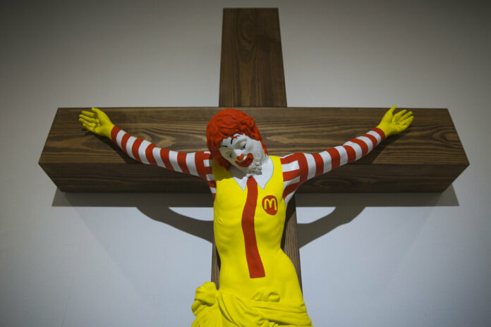 A sculpture called 'McJesus' by Finnish artist Jani Leinonen, which depicts a crucified Ronald McDonald, is seen on display Monday as part of the Haifa museum's 'Sacred Goods' exhibit, in Haifa, Israel. Photo: Oded Balilty / Associated Press