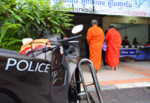 Walls and Wire to Secure Deep South Temples After Monks Killed Police accompany monks as they collect alms Sunday in Yala province.
