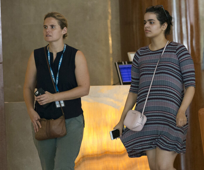 Rahaf Mohammed Alqunun, at right, walks with an unidentified woman Friday in Bangkok. Photo: Sakchai Lalit / Associated Press