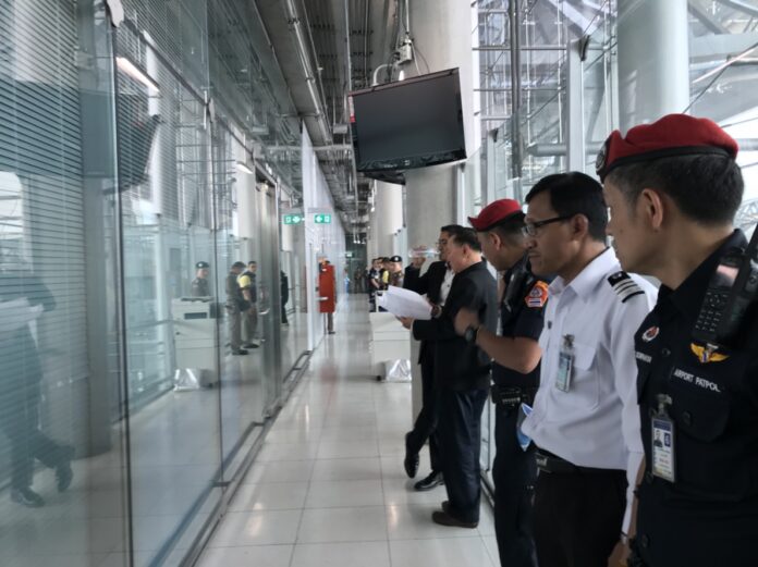 Officers in front of the Immigration Bureau Police operation center on Monday afternoon at Suvarnabhumi International Airport in Bangkok.