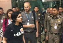 Australia Considers Taking in Rahaf as UN Grants Refugee Status Rahaf Mohammed Alqunun, at left, walks by Thai immigration police chief Maj. Gen. Surachate Hakparn, at right, on her way out of Suvarnabhumi Airport on Monday in Bangkok. Photo: Immigration Bureau Police / Courtesy