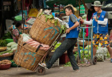 Opinion: Unequal Thailand a Daily Struggle A worker at Bangkok's Khlong Toei Market. Photo: Mark Fisher