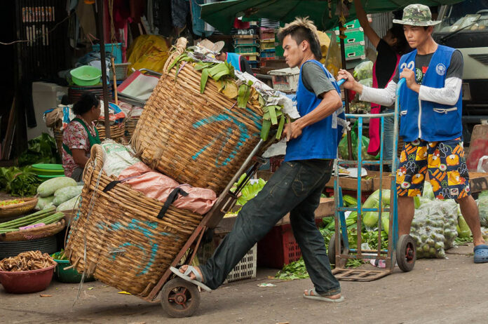A worker at Bangkok's Khlong Toei Market. Photo: Mark Fisher