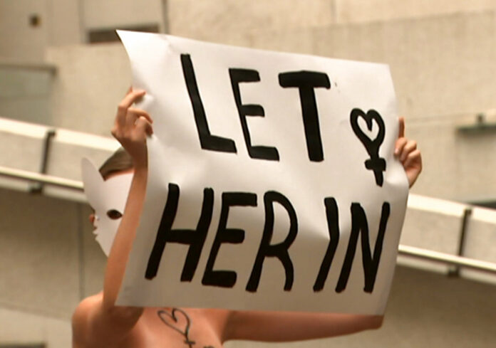 A woman protester marches Thursday with a sign outside the building housing the Saudi consulate in Sydney. Image: Australia Broadcast Corporation via AP A woman protester marches Thursday with a sign outside the building housing the Saudi consulate in Sydney. Image: Australia Broadcast Corporation via AP
