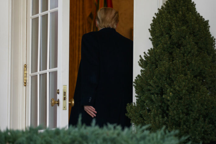 US President Donald Trump walks back into the Oval Office after announcing a deal to temporarily reopen the government Friday in the Rose Garden of the White House. Photo: Evan Vucci / Associated Press