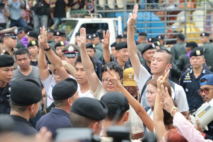 Pro-democracy protesters raise the anti-junta three finger salute on May 22, 2018.