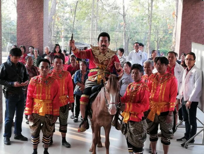 Dramatic Entry: Pheu Thai Party candidate Saranwut Saranket rolled up on the Uttaradit province registration center on horseback in a Thai warrior costume,saying he was there to kick out the dictatorship.