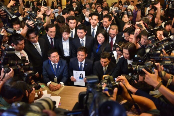 Thai Raksa Chart Party members reveal Princess Ubolratana Mahidol as their nominee for prime minister Friday morning at the Election Commission headquarters.