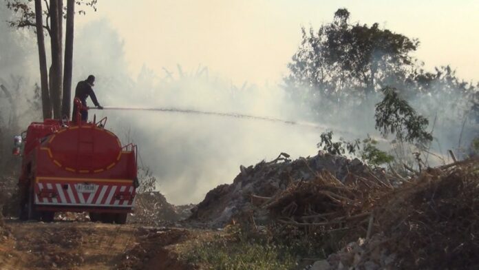 A worker tries to put out forest fire in Phrae province in this undated photo.