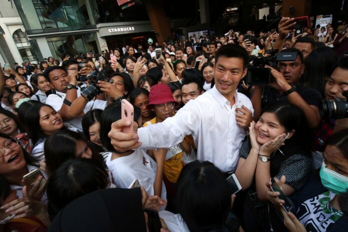 Thanathorn Juangroongruangkit, Future Forward Party leader, takes a selfie with supporters at a campaign rally Wednesday in Bangkok’s Siam Square.