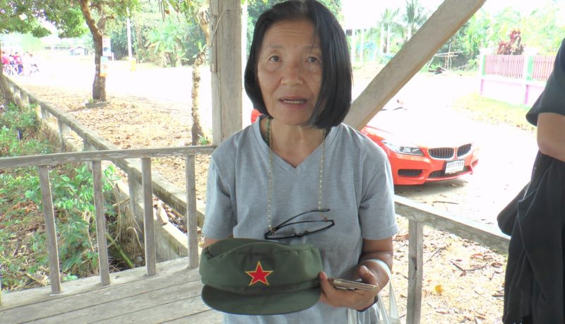 Pranee Danwattanusorn holds a hat of her missing husband Surachai Danwattanusorn Monday before seeing police in Nakhon Phanom province.