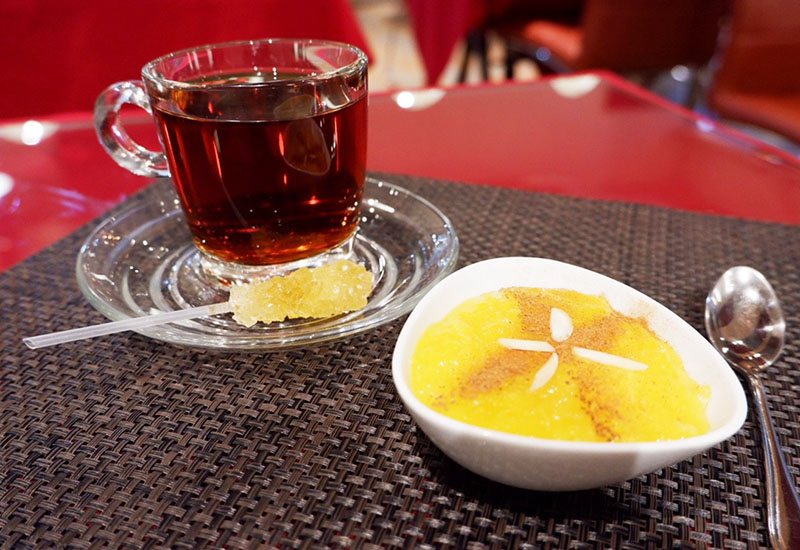 Black Persian tea (40 baht/cup, 70 baht/pot) with sholeh zard, a saffrom rice pudding topped with cinnamon (60 baht).
