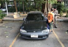 Cop Busted Breaking Into Car, Stealing – At Police HQ Capt. Ekkachai Pengjan, left, stands Sunday next to an investigator by a car he was accused of breaking into at the police headquarters in Bangkok.