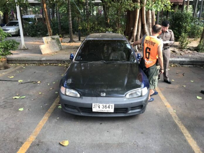 Capt. Ekkachai Pengjan, left, stands Sunday next to an investigator by a car he was accused of breaking into at the police headquarters in Bangkok.