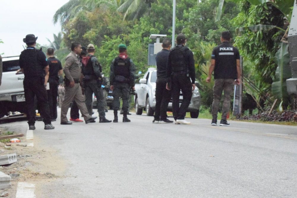 Authorities on Wednesday patrol the scene where the bodies of two local police officers were found in Narathiwat province.