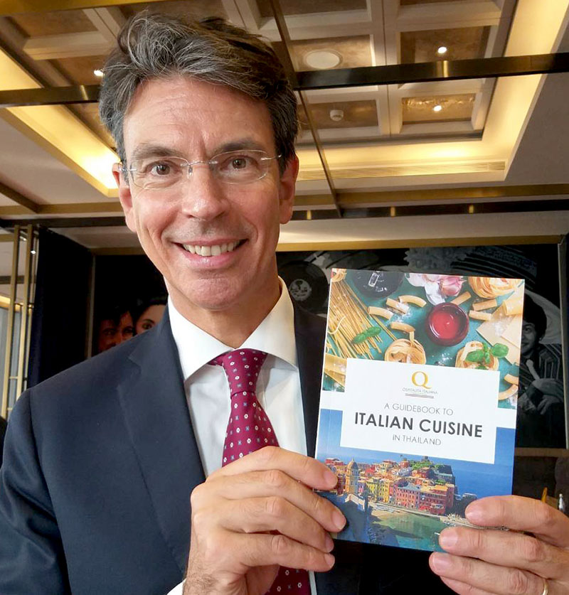 Italian Ambassador Lorenzo Galanti holds a copy of the new ‘Guidebook to Italian Cuisine in Thailand’ on Wednesday in Bangkok.