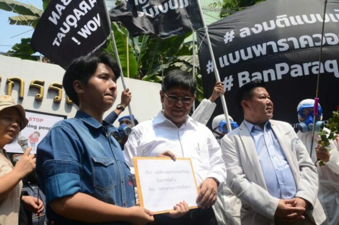 Advocates for banning paraquat, a popular herbicide linked to serious illness in humans, protest Thursday outside the Industry Ministry in Bangkok.