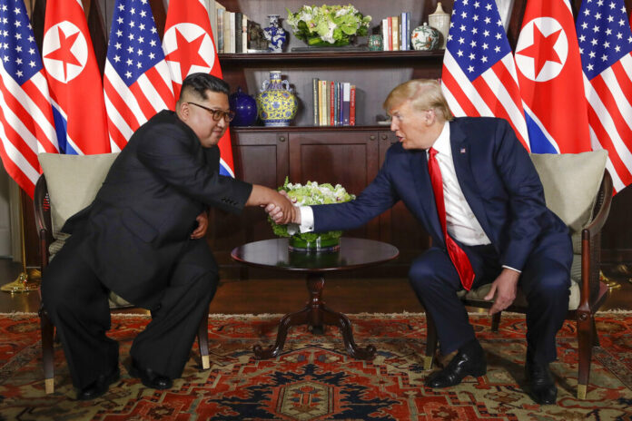 FILE - In this June 12, 2018, file photo, North Korea leader Kim Jong Un, left, and U.S. President Donald Trump shake hands during their first meeting at the Capella resort on Sentosa Island in Singapore. Photo: Evan Vucci / Associated Press
