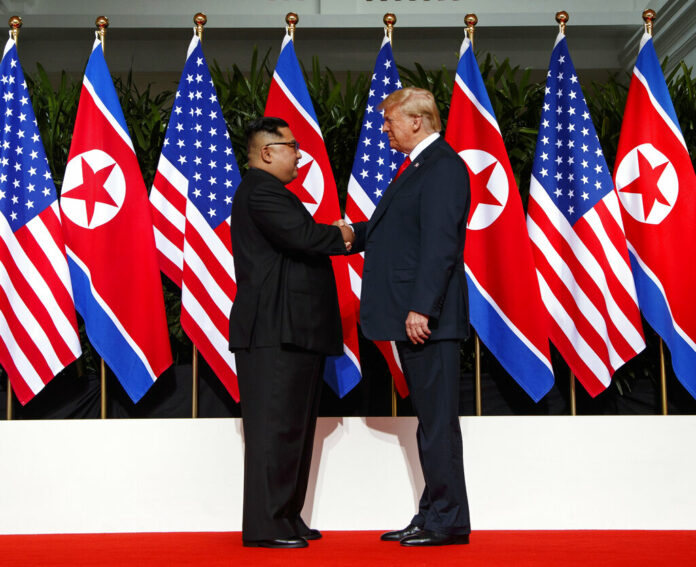 North Korean leader Kim Jong Un, left, and U.S. President Donald Trump shake hands prior to their meeting in June on Sentosa Island in Singapore. Photo: Evan Vucci / Associated Press