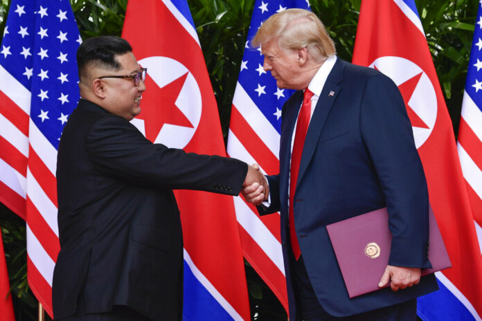 North Korea leader Kim Jong Un, left, and U.S. President Donald Trump shake hands at the conclusion of their meetings in June at the Capella resort on Sentosa Island in Singapore. Photo: Susan Walsh / Associated Press