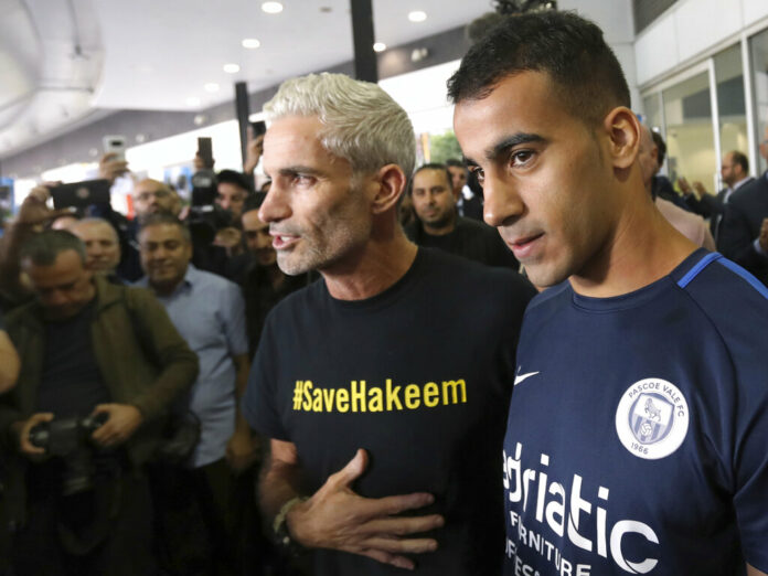 Refugee soccer player Hakeem Al-Araibi, right, arrives Tuesday in Melbourne, Australia. David Crosling / Associated Press