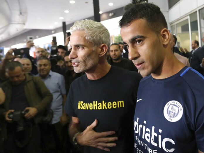 Refugee soccer player Hakeem Al-Araibi, right, arrives Tuesday in Melbourne, Australia. David Crosling / Associated Press Refugee soccer player Hakeem Al-Araibi, right, arrives Tuesday in Melbourne, Australia. David Crosling / Associated Press