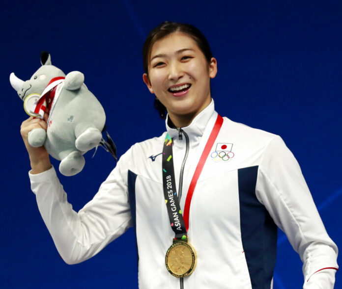 Japan's Rikako Ikee poses on the podium after winning the women's 100m freestyle final during the swimming competition at the 18th Asian Games in 2018 in Jakarta, Indonesia. Photo: Bernat Armangue / Associated Press