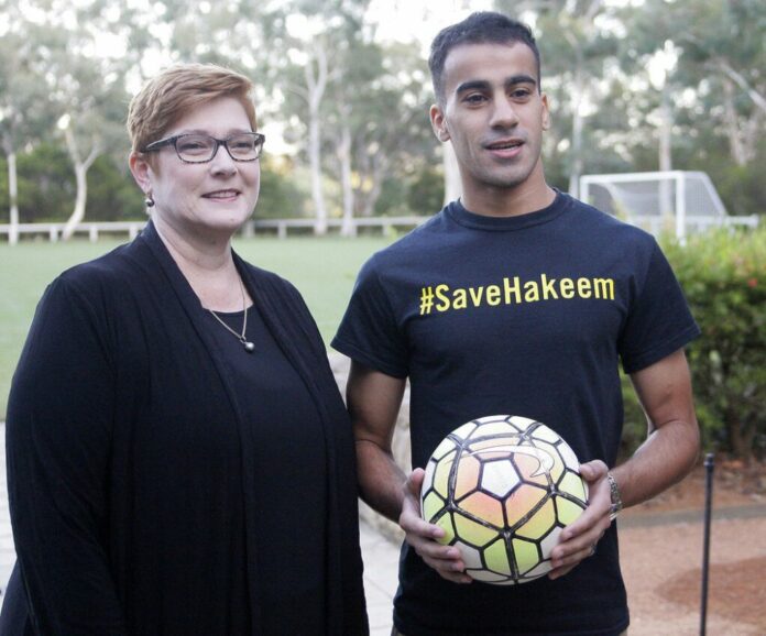 Australian Foreign Minister Marise Payne, left, and refugee soccer player Hakeem al-Araibi pose on Thursday for a photograph before a soccer match at Parliament House in Canberra, Australia. Photo: Rod McGuirk / Associated Press
