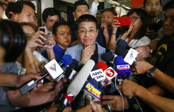 Maria Ressa listens to a reporter's question after posting bail at a Regional Trial Court following an overnight arrest by National Bureau of Investigation agents on a libel case Thursday in Manila, Philippines. Photo: Bullit Marquez / Associated Press