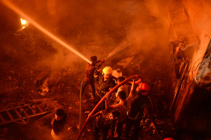 In this Wednesday, Feb. 20, 2019, photo, firefighters try to douse flames in Dhaka, Bangladesh. Photo: Associated Press